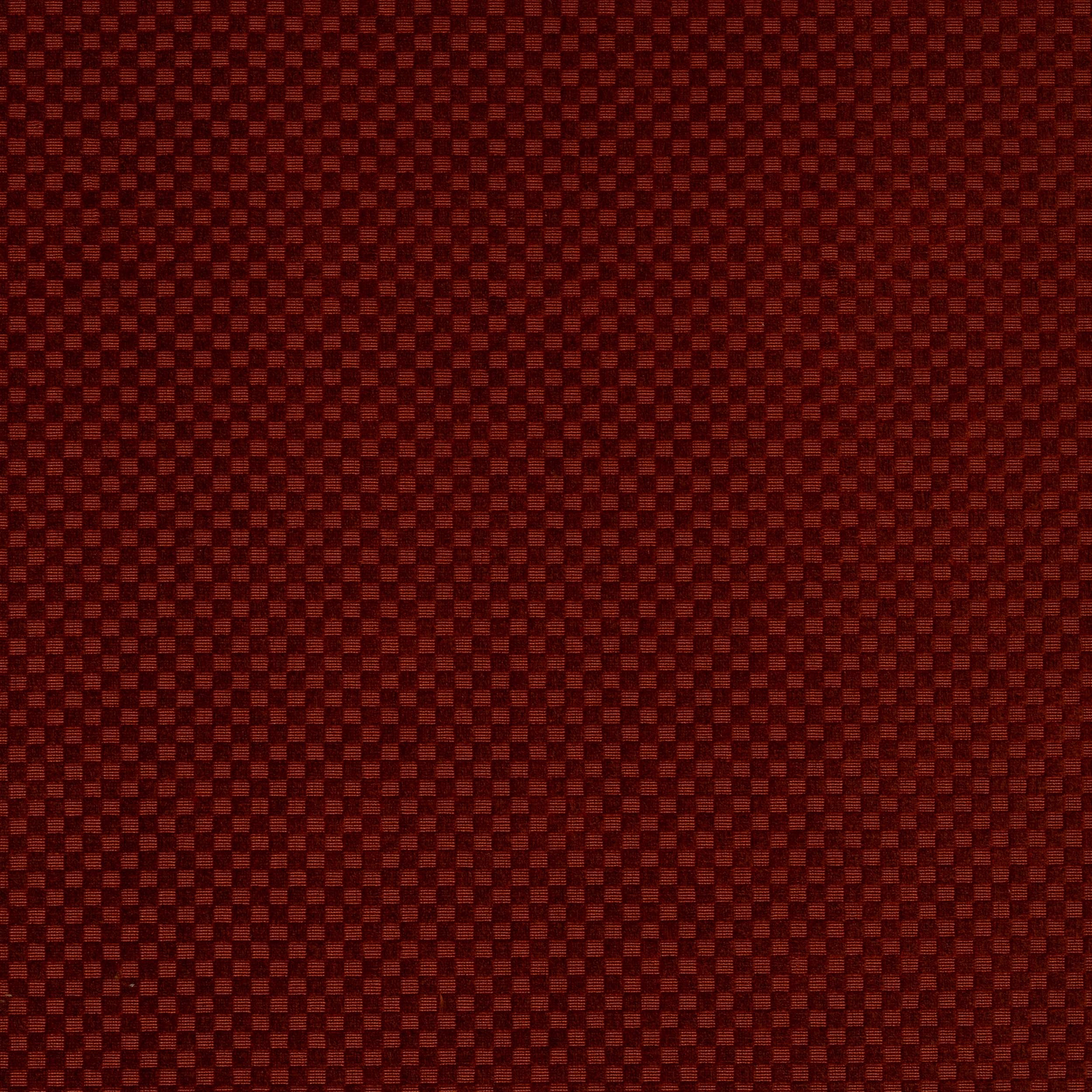 Close-up of a deep brick-red small check woven fabric with subtle tonal texture