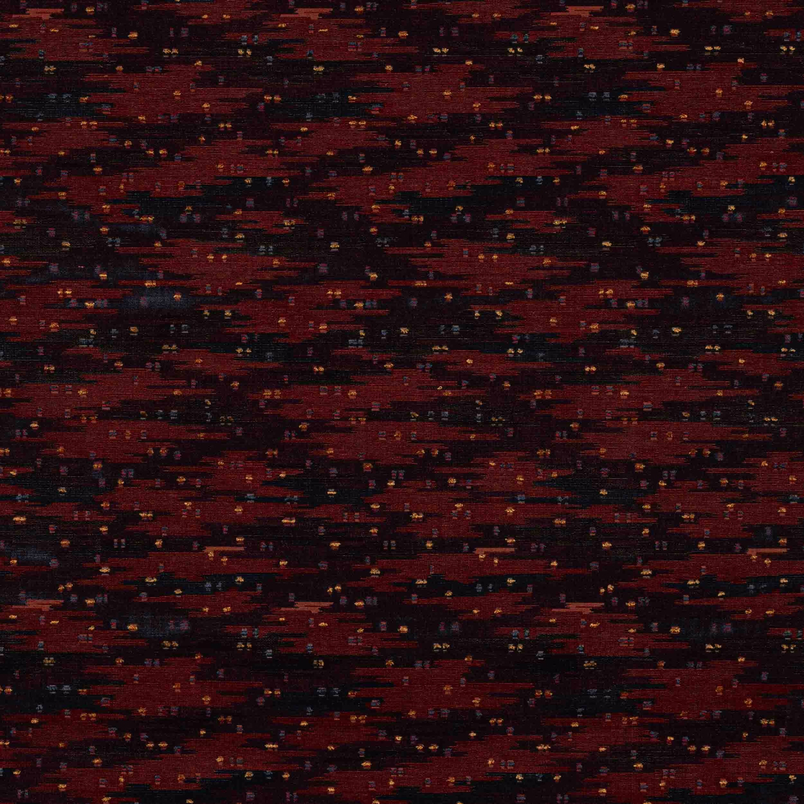Close-up of a deep spice red and black woven fabric with tiny flecks
