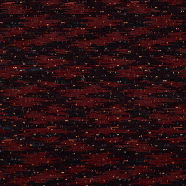 Close-up of a deep spice red and black woven fabric with tiny flecks