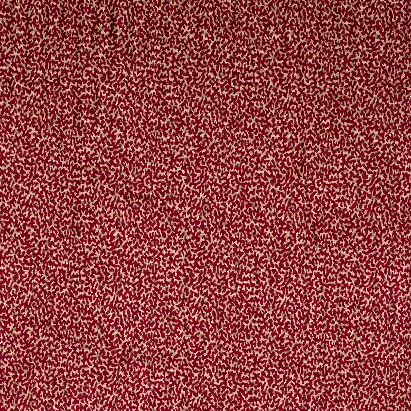 Close-up of deep scarlet abstract velvet with cream flecks and soft pile