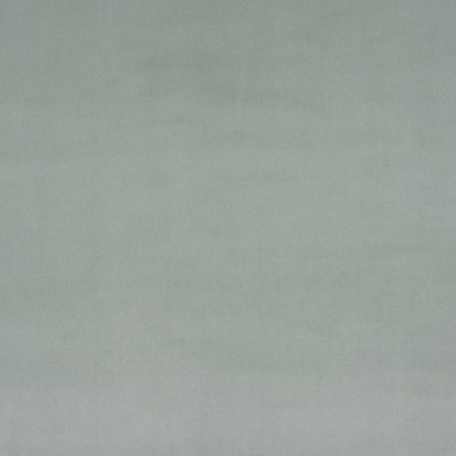 Soft celadon green plain fabric with a smooth, matte finish
