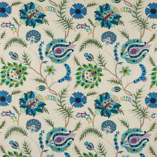 Blue and green floral patterned fabric with scrolling stems on a pale ground