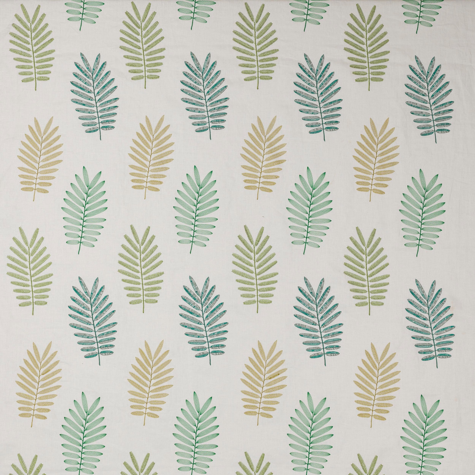 Repeating botanical leaf print in soft emerald, sage and yellow-green on a pale ground