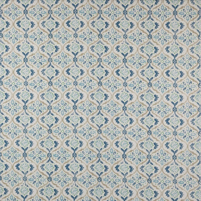 Swatch of small repeating blue and sage geometric medallions on an ivory cotton ground