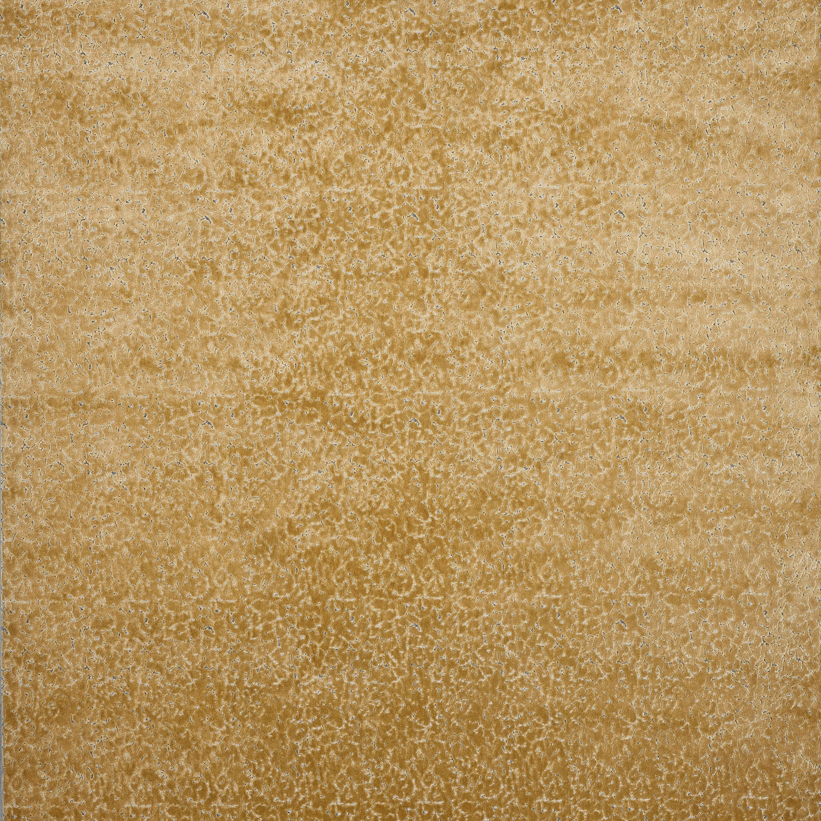 Close-up of biscuit-gold textured velvet with a softly speckled surface