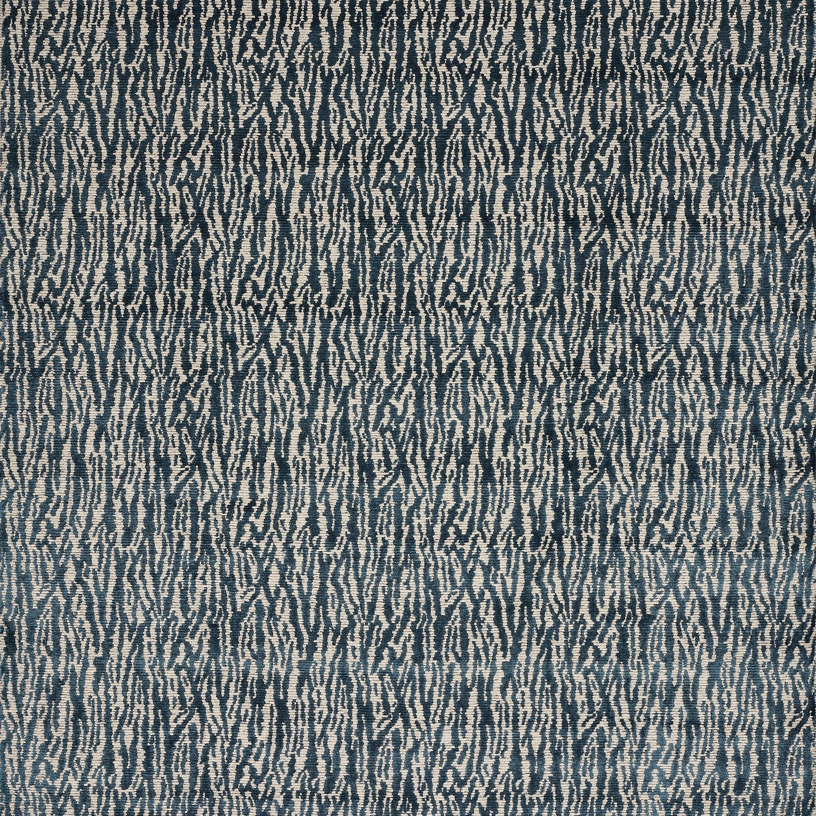 Blue velvet swatch with a small abstract broken-line pattern in dark teal and pale ground