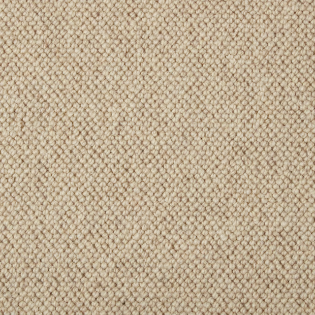 Warm oatmeal-beige carpet with tightly packed looped texture and subtle tonal flecks