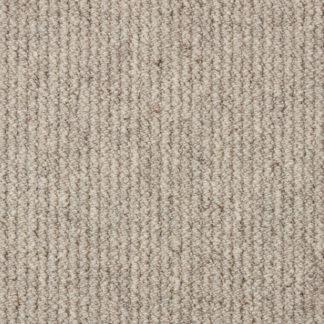 Warm stone-beige carpet with dense flecked loops in subtle vertical rows