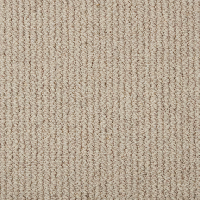 Warm husk beige carpet with dense nubby wool loops in softly varied vertical rows