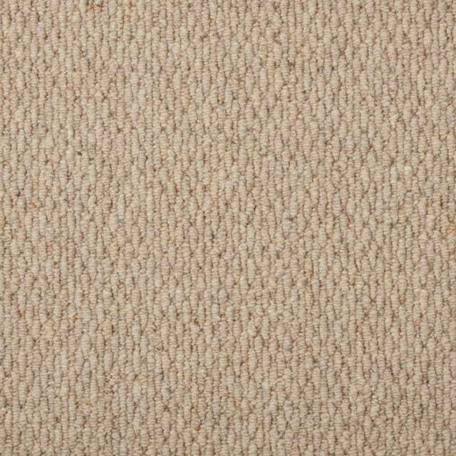 Warm oat-beige carpet with dense irregular loop rows and subtle taupe flecks