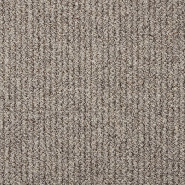 Warm grey-taupe wool loop carpet with dense ribbed texture and subtle flecks