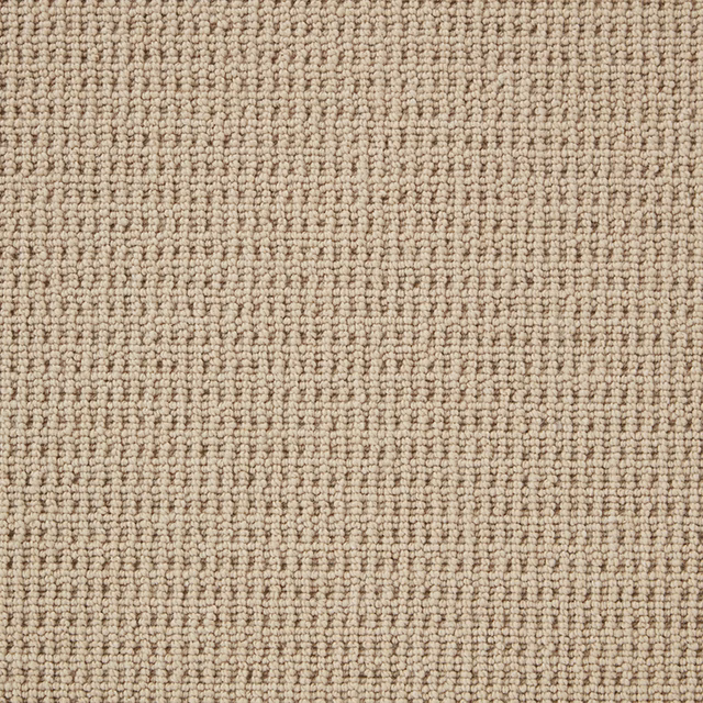 Close-up of softly flecked stone beige Wool Loop carpet with dense rows of small loops