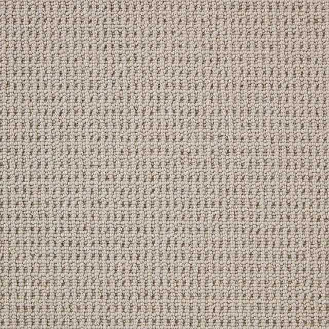 Warm stone-beige carpet with tightly packed rows of small wool loops