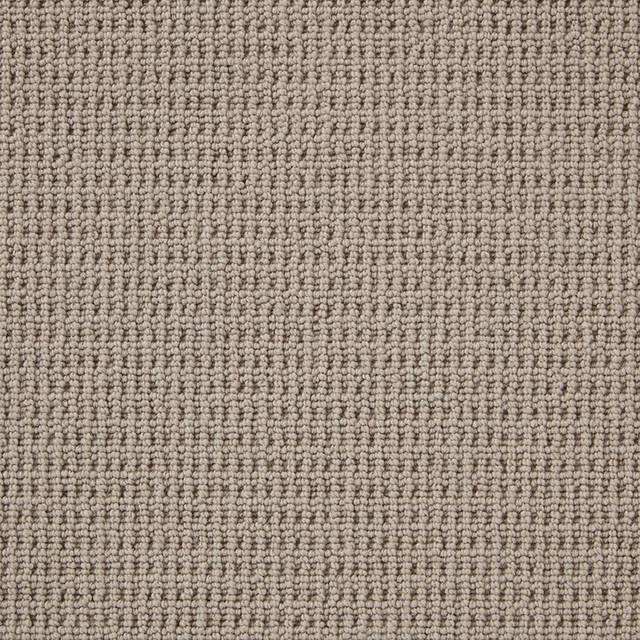 Close-up of taupe-grey wool loop carpet with fine ribbed rows and mottled texture