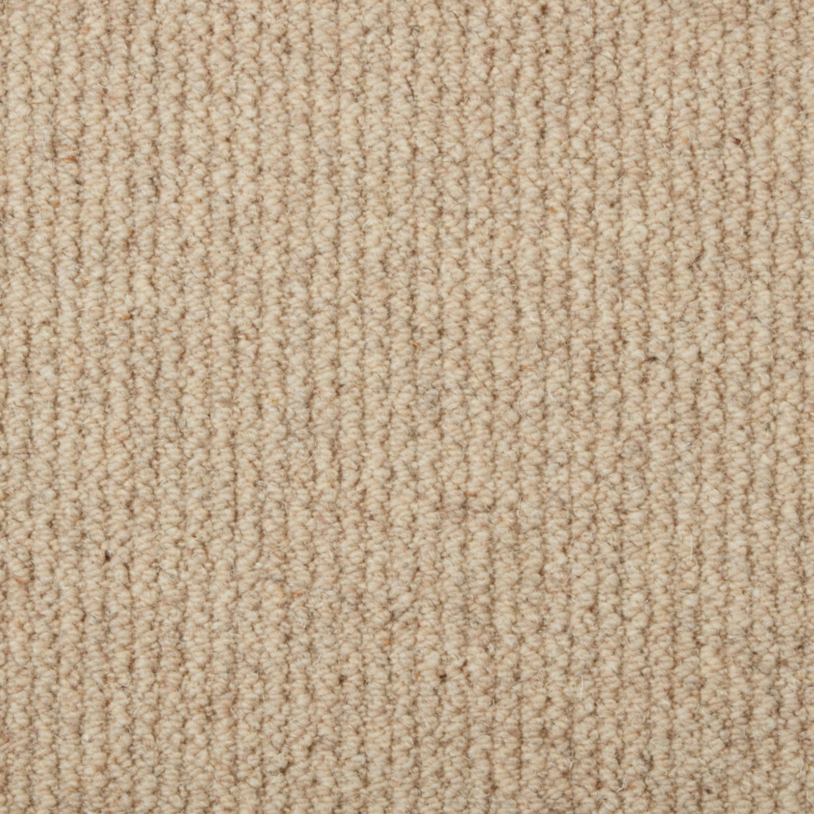 Warm oat-beige carpet showing dense, irregular vertical loop texture