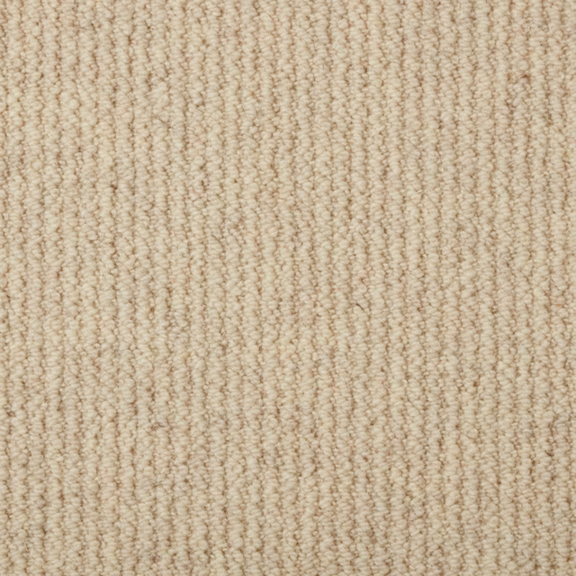 Warm oatmeal beige loop carpet with fine vertical ridges and flecked texture