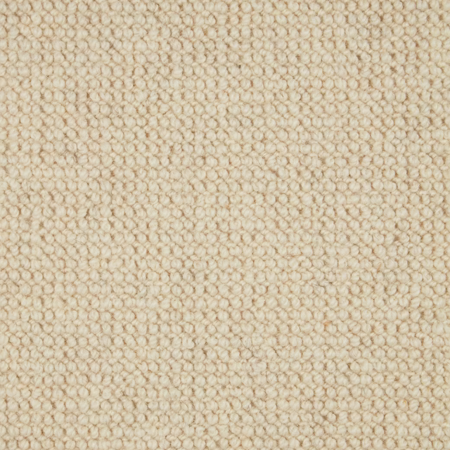 Warm oatmeal-beige wool loop carpet with dense, softly pebbled texture