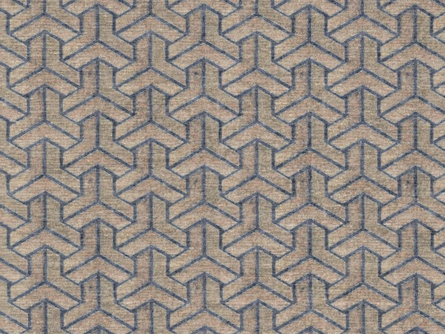 Warm beige chenille with slate-blue interlocking geometric lines and soft woven texture