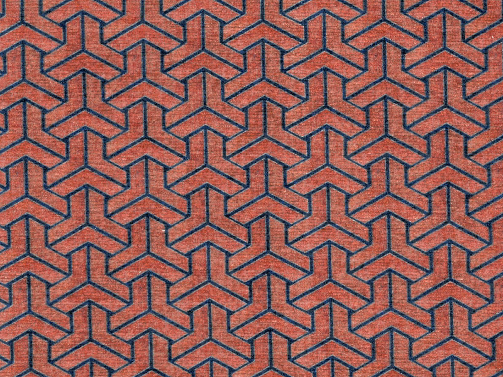 Terracotta chenille swatch with dark teal interlocking geometric lines and tactile weave