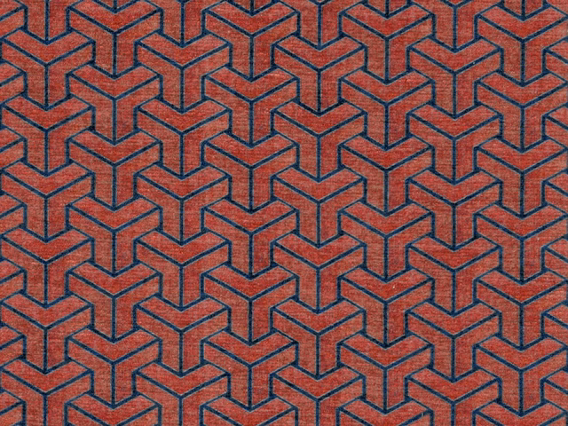Terracotta-red chenille with navy interlocking cube geometry and softly napped texture