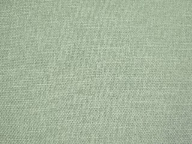 Soft sage-green faux linen with a subtle crosshatched woven texture