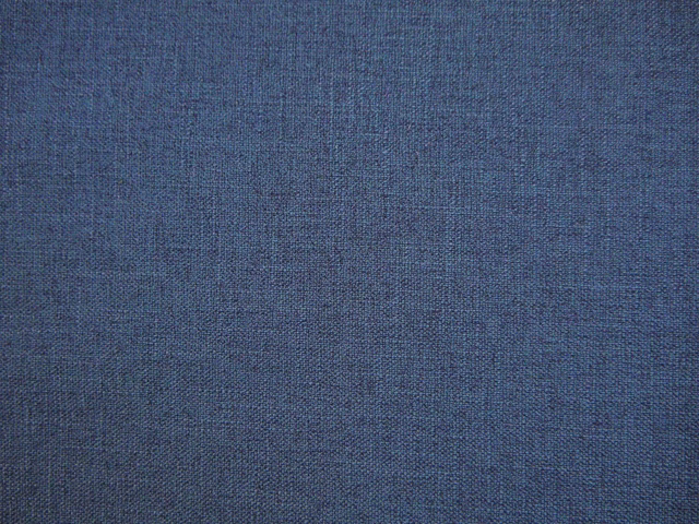 Muted slate-blue faux linen showing a fine, softly varied woven crosshatch texture