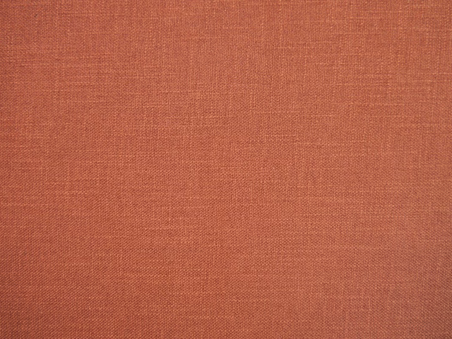 Muted rust terracotta faux-linen weave with fine tonal texture