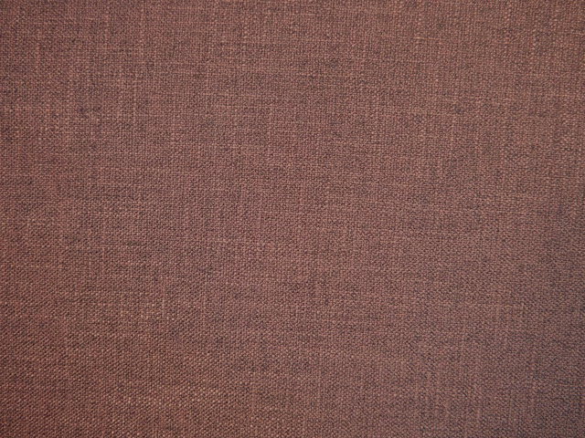 Close-up of muted rose-brown faux linen with a fine, subtly varied weave