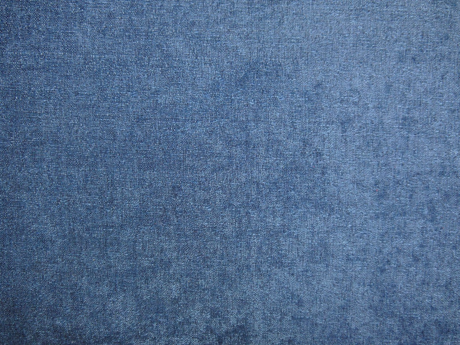 Close-up of muted denim-blue chenille with a softly mottled, brushed surface
