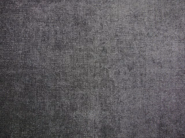 Dark charcoal-grey chenille with a finely mottled woven texture catching the light