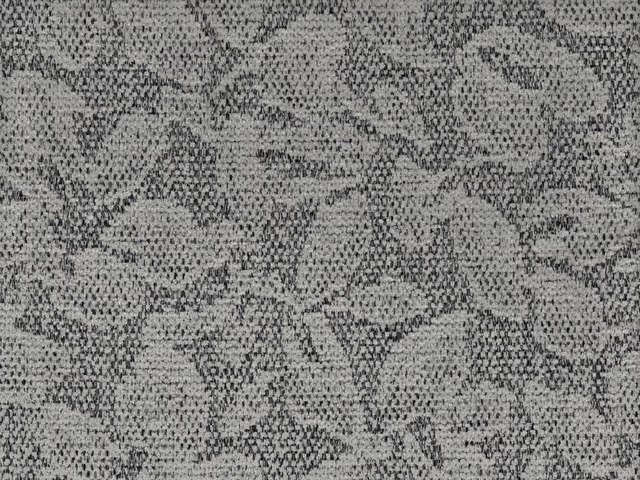 Cool grey chenille with mottled charcoal leaf-like outlines and a nubby woven surface