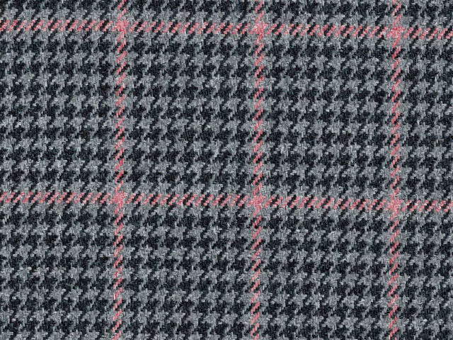 Charcoal grey houndstooth check with fine pink windowpane lines in a textured flat weave