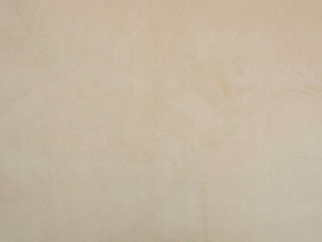 Pale warm-cream velvet with subtle cloudy mottling and a softly reflective pile