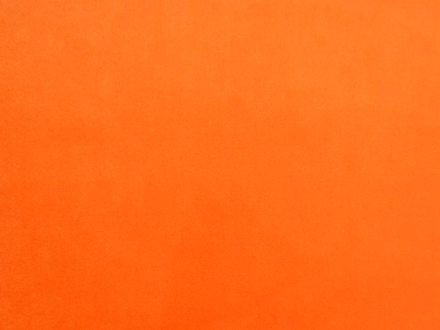Vivid tangerine-orange velvet with subtle vertical nap shading across the swatch