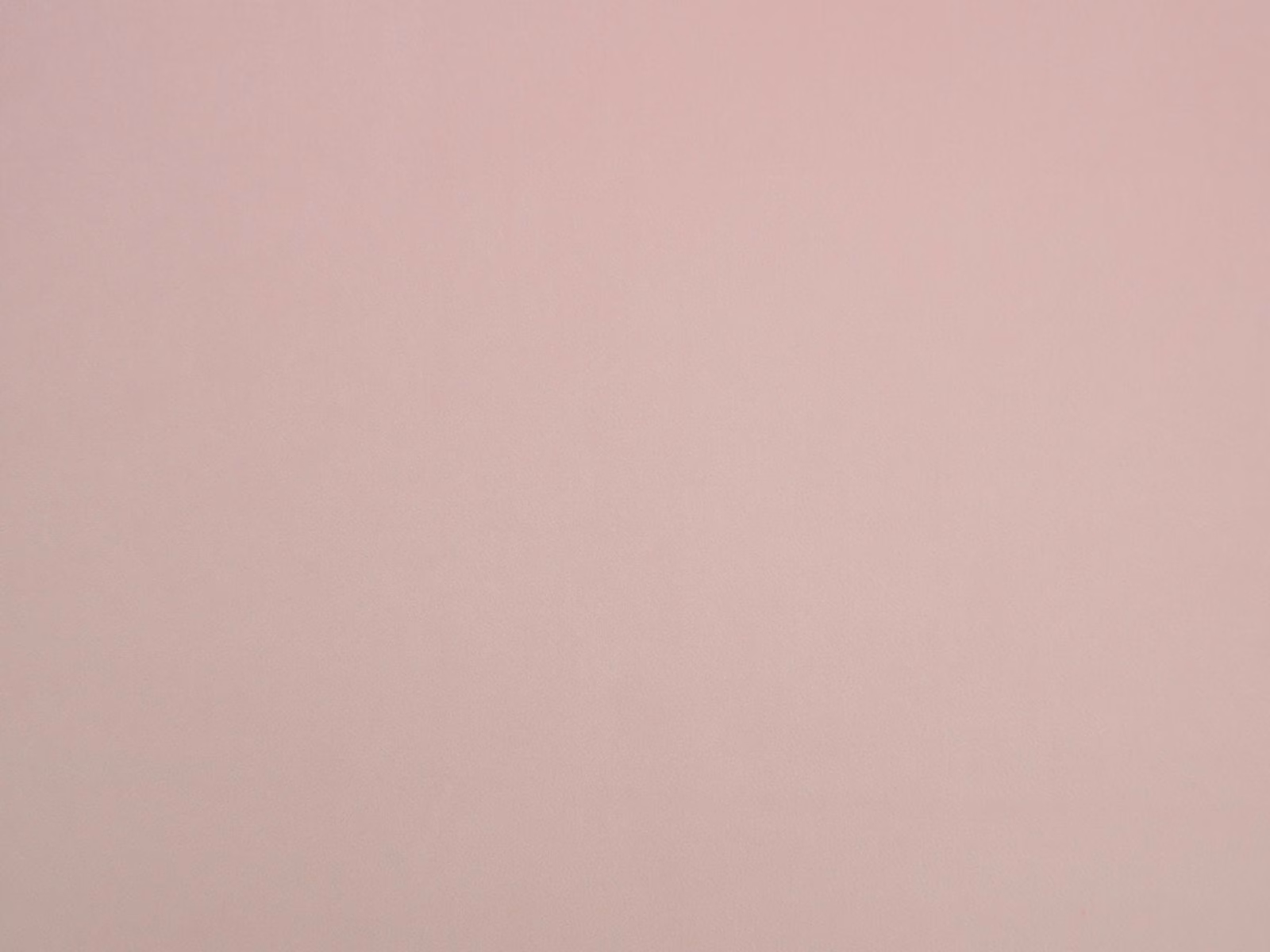 Dusty blush pink velvet showing a smooth surface and subtly shifting pile