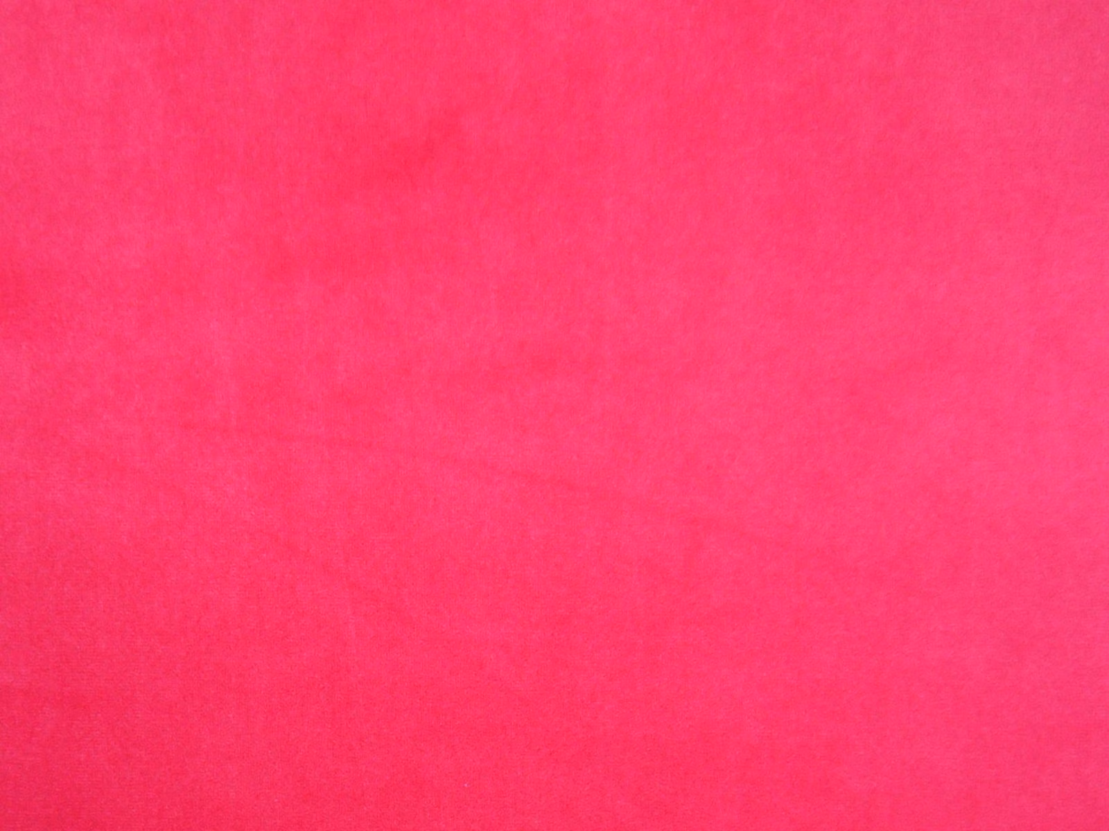 Vivid fuchsia-pink velvet swatch with smooth pile and subtle tonal shading
