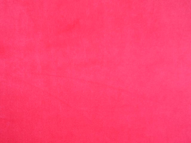 Vivid fuchsia-pink velvet swatch with smooth pile and subtle tonal shading