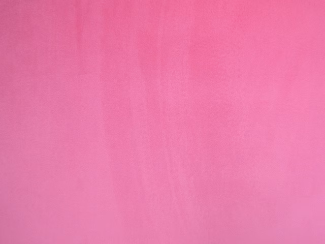 Saturated raspberry-pink velvet swatch with subtle vertical nap and soft sheen