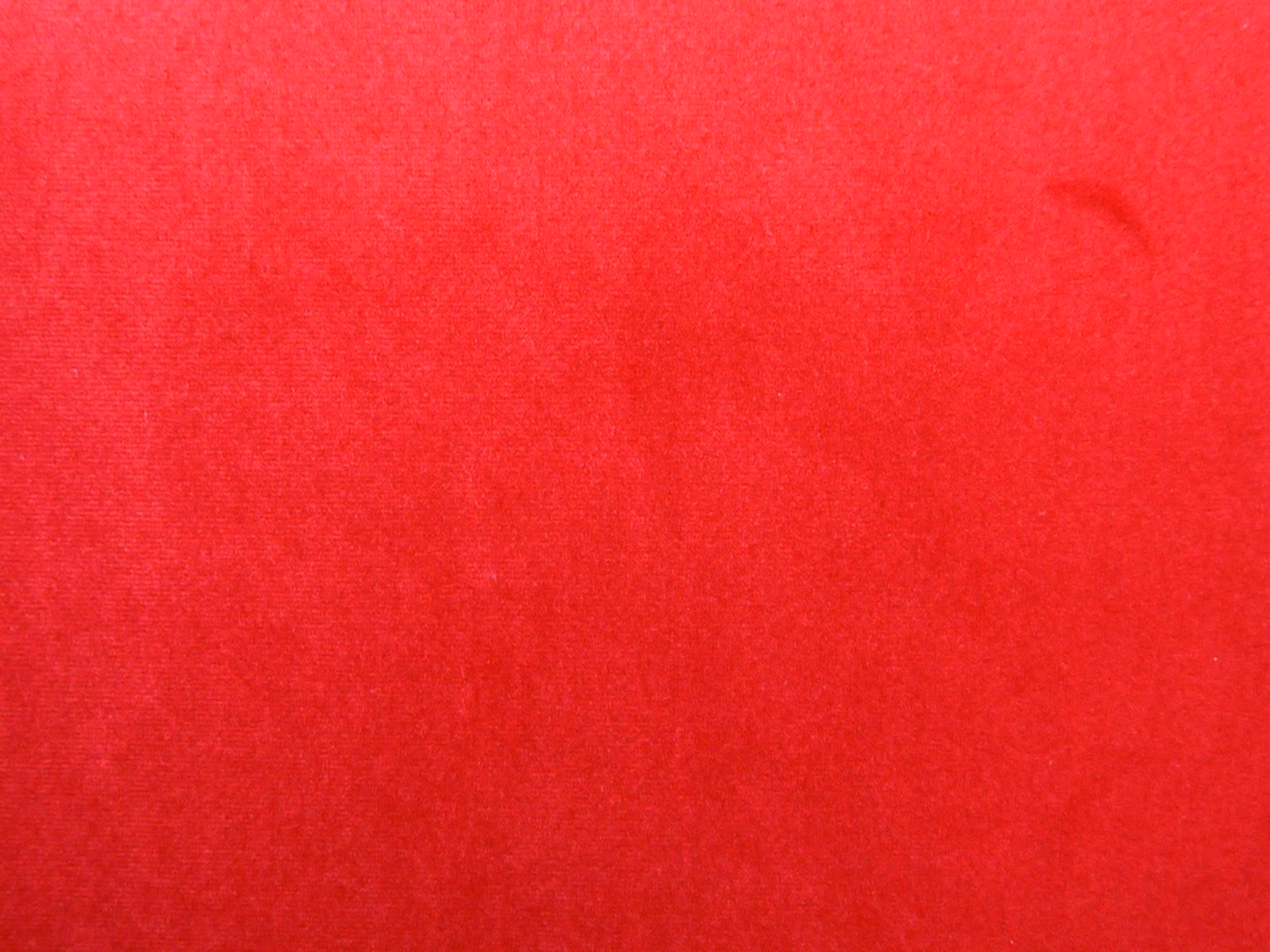 Vivid crimson red velvet swatch showing subtle nap direction and tonal sheen
