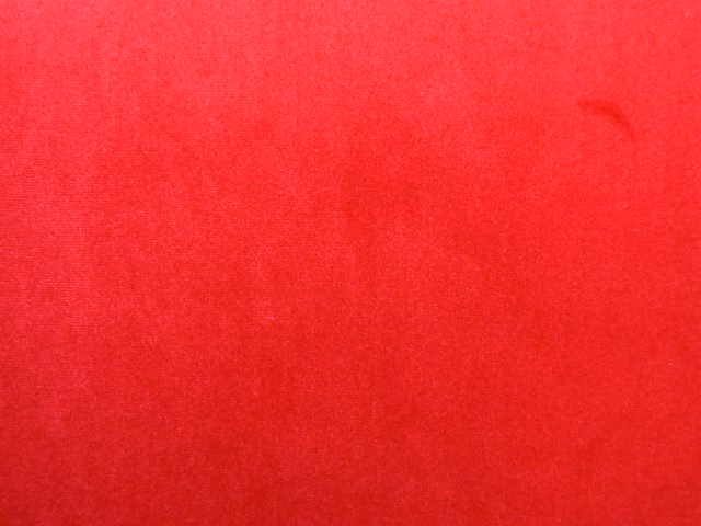 Vivid crimson red velvet swatch showing subtle nap direction and tonal sheen