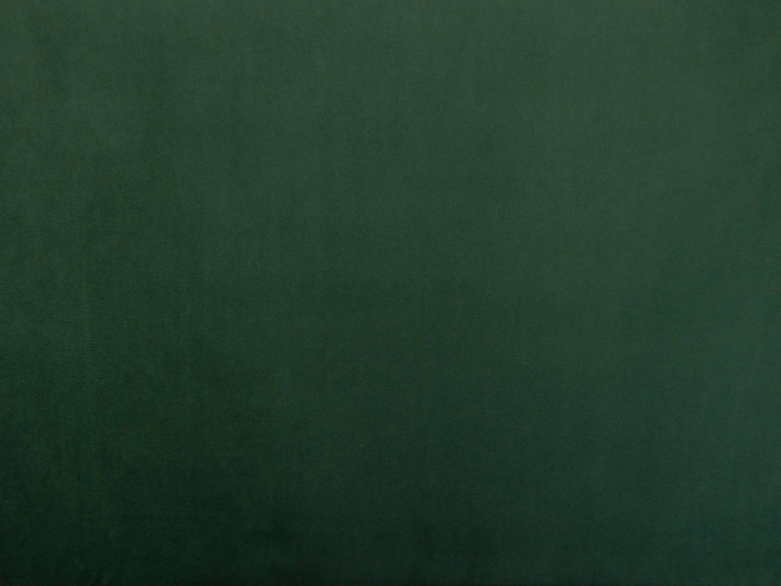 Deep forest-green velvet with a softly shifting, low-lustre pile