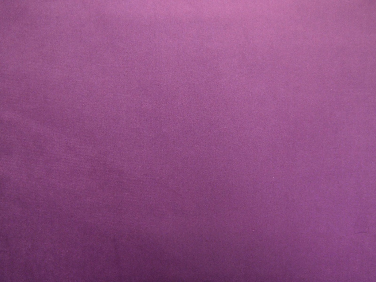 Rich berry-purple plain velvet showing soft pile and subtle plum shading