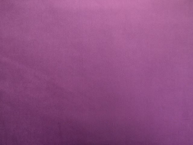 Rich berry-purple plain velvet showing soft pile and subtle plum shading