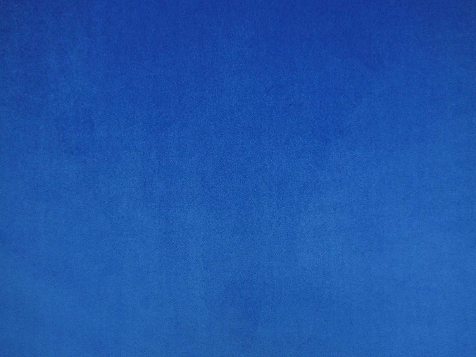 Deep cobalt-blue velvet swatch showing smooth pile and subtle tonal nap variation