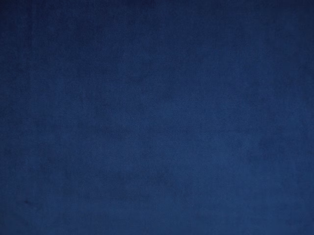 Deep ink-blue velvet swatch showing a softly brushed, subtly tonal surface