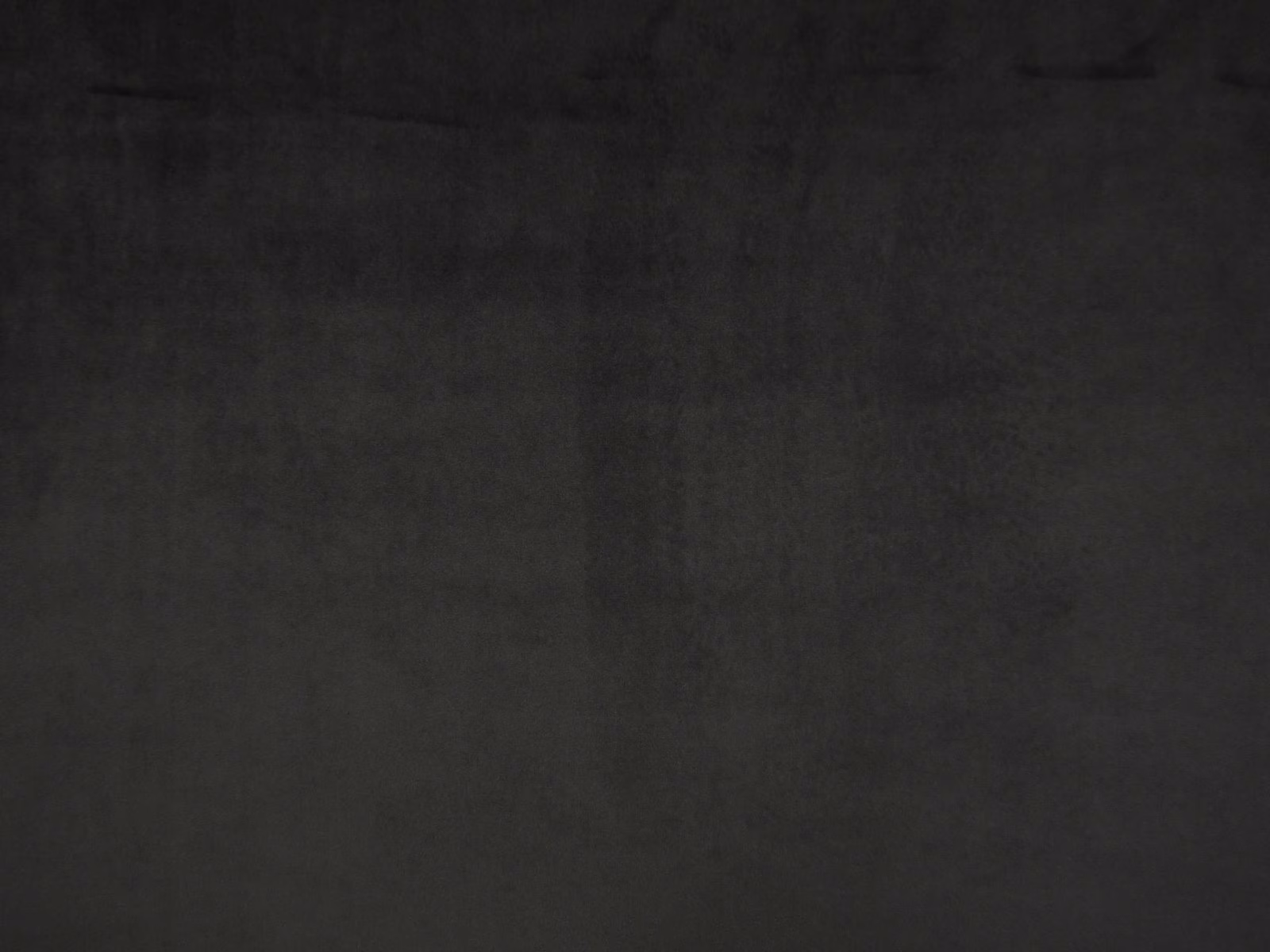 Charcoal-black plain velvet swatch showing a plush nap and subtle tonal sheen