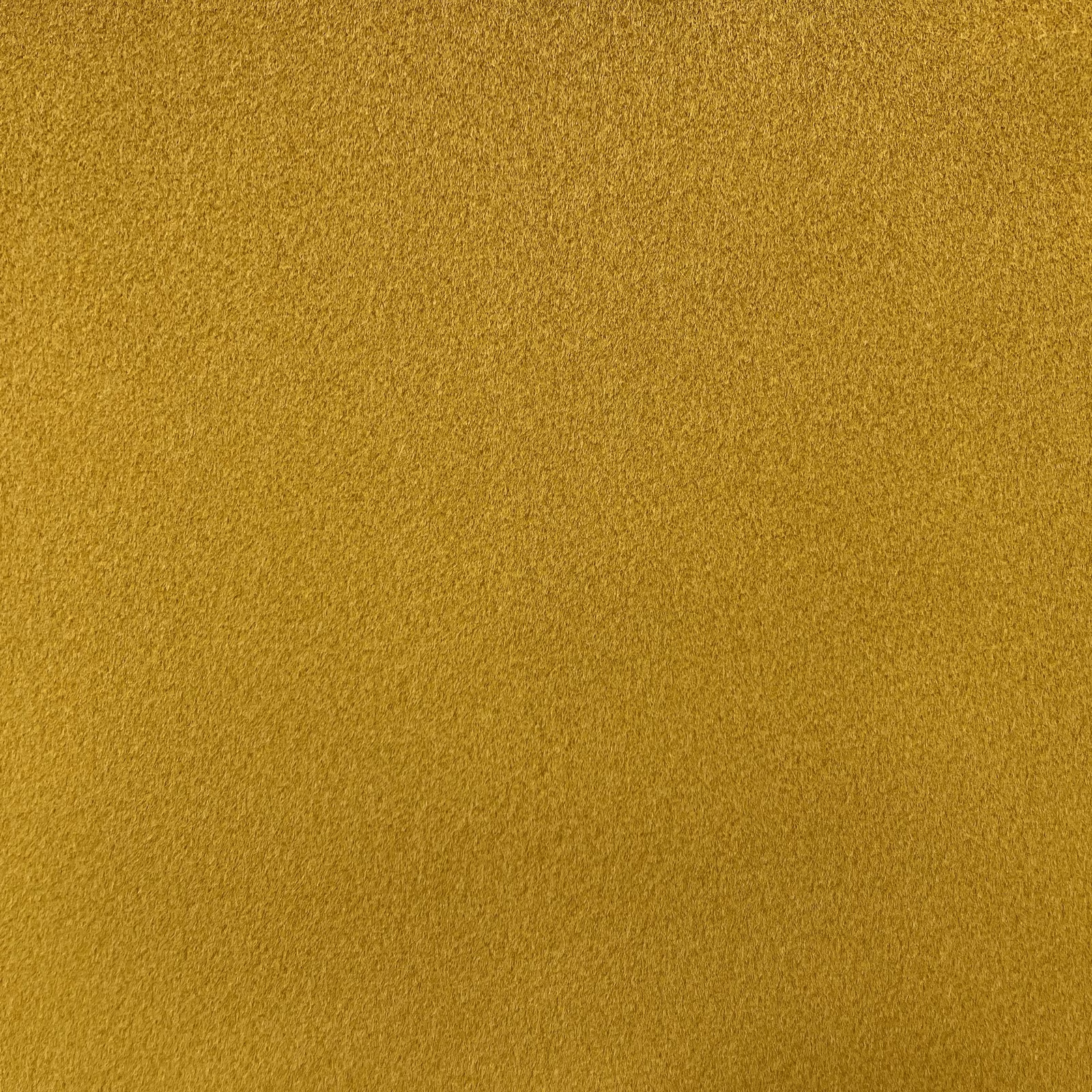 Close-up of muted mustard ochre chenille with a softly pebbled surface