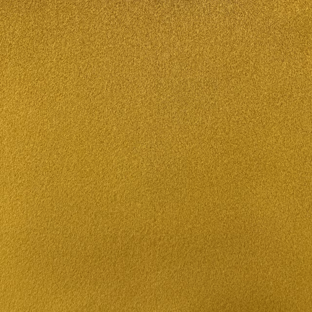 Close-up of muted mustard ochre chenille with a softly pebbled surface