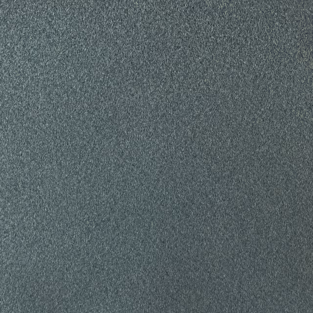 Close-up of dark blue-charcoal chenille with a softly mottled, low-pile surface