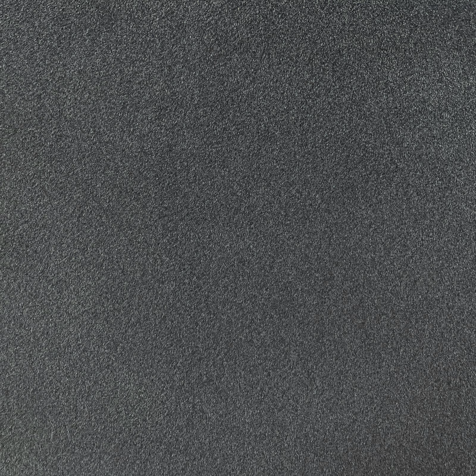Close-up of deep charcoal-grey chenille with a fine softly mottled weave